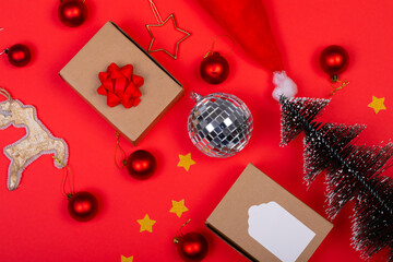 Composition of multiple christmas decorations with baubles and presents on red background