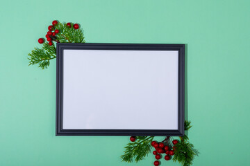 Composition of white card in frame with copy space and tree branches on green background