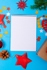 Composition of notebook with copy space and christmas decorations on blue background