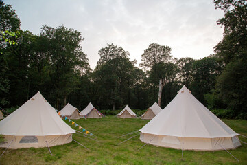 Glamping teepees in a circle in a field