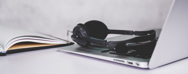 Laptop computer and headphone on desk, e-learning online, webinar for education and learning,...