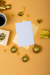 Composition of white card with copy space and christmas decorations with coffee on yellow background