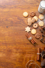 Composition of ginger man cookie cutters with christmas cookies and copy space on wooden background