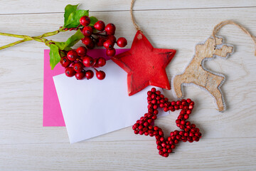 Composition of cards with copy space and christmas decorations on wooden background