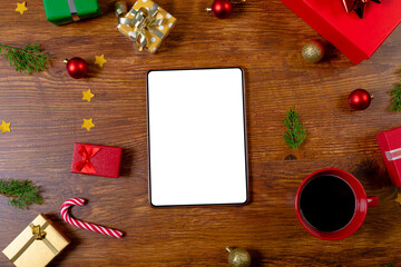 Composition of tablet with copy space and christmas decorations on wooden background