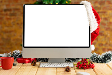 Composition of computer with copy space on wooden table with christmas decorations
