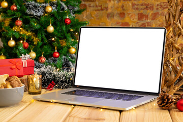Composition of laptop with copy space on wooden table with christmas decorations