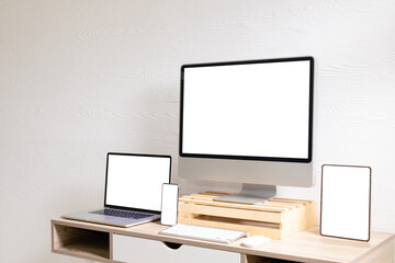 Composition of desktop computer, laptop, tablet and smartphone with copy space on white background
