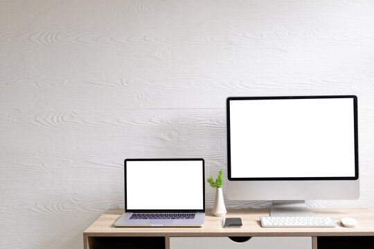 Composition of desktop computer and laptop with copy space on white background