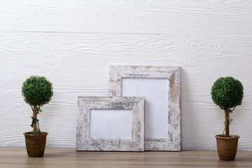 Composition of white cards in frames with copy space and decorations on white background
