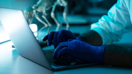 Close Up Shot of a Scientist Hands Wearing Medical Gloves While Typing Into The Computer New Data...