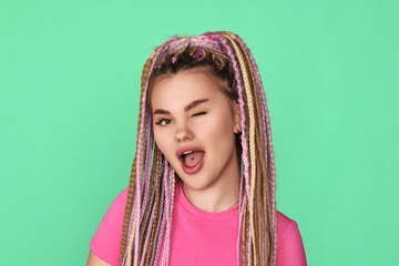 Winking woman with dreadlocks on blue background.