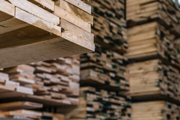 Stacks of lumber on a rack for sale to consumers at a retail hardwood lumber business