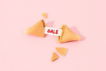 Creative composition with fortune cookie and paper with text on pink background
