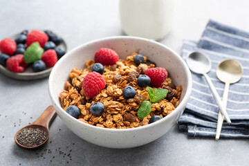 Granola bowl with berries and almond milk. Healthy breakfast or snack