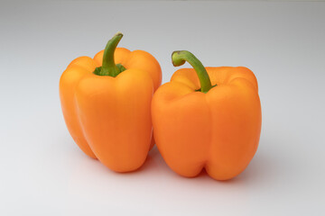 Two orange bell peppers isolated on white background