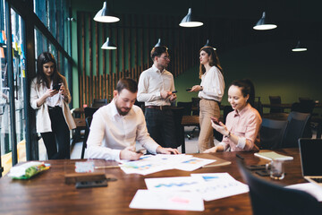Group of colleagues gathering in spacious office
