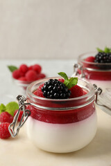 Delicious panna cotta with fruit coulis and fresh berries on light table