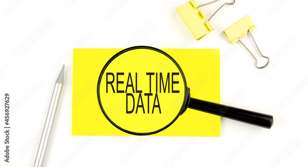 Poster real time data text on the sticker through magnifier. view from above. business concept
