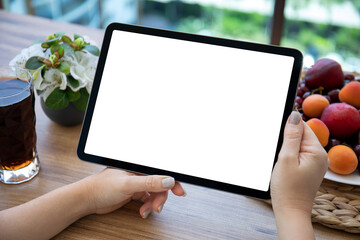 female hands holding computer tablet with isolated screen in cafe