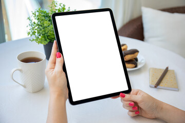 female hands holding computer tablet with isolated screen in cafe © DenPhoto