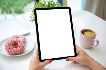 female hands holding computer tablet with isolated screen in cafe © DenPhoto