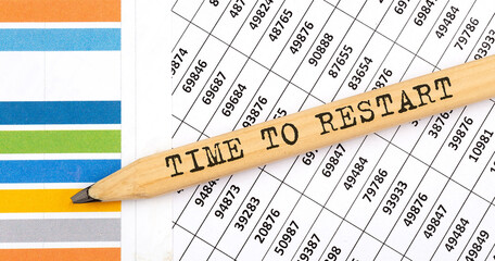 Business concept TIME TO RESTART text on the pencil on chart background