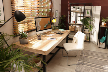 Light room interior with comfortable workplace near window