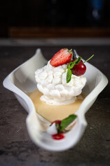 meringue with strawberries on a beautiful white plate