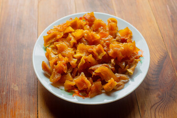 Ripe fresh healthy diet vegetarian food with vitamins. Candied pumpkin fruits on a plate. Harvesting season.