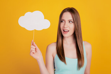 Portrait of tempting curious charming lady hold cloud stick look empty space on yellow background