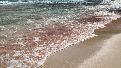 Pink sand in Balos lagoon with  crystal blue water, Crete island, Greece.