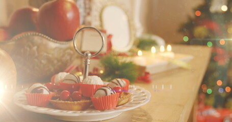 Image of decorated christmas tree and table with christmas desserts