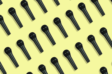 black microphones pattern on yellow background