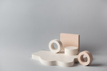 Minimal abstract cosmetic background for product presentation. Cosmetic bottle podium on grey color background. Pastel colors styled composition with geometrical forms. Minimal concept. Product mockup
