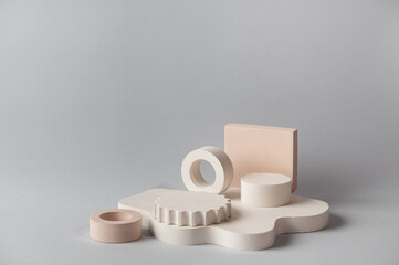 Minimal abstract cosmetic background for product presentation. Cosmetic bottle podium on grey color background. Pastel colors styled composition with geometrical forms. Minimal concept. Product mockup