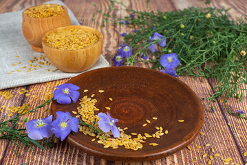 Flax seeds and flowers on the table.