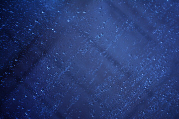 Abstract image of fogged glass with drops running down it.