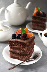 Chocolate piece of cake with berries and fruits on top
