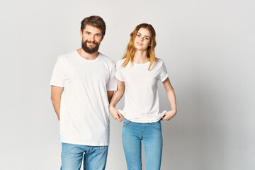 man and woman in white t-shirts and jeans design fashion copy space studio