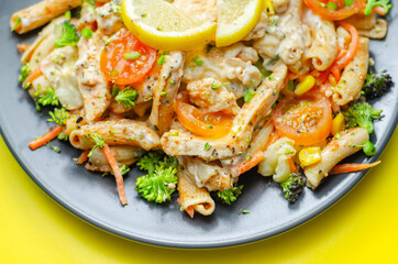 Piri piri style chicken on a bed of wholewheat pasta and vegetables, with a cool sour cream and chive dressing