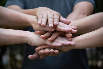 People join hands together for cooperation  more power to teamwork,partnership and collaboration .to drive business goal achievement,copy space,selective focus.