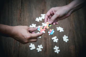 Stakeholders business team hands holding  jigsaw puzzle  as collaboration,connection and teamwork for business growth, business solution concept.selective focus.