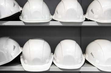 Construction white helmets stand in a row on the table.
