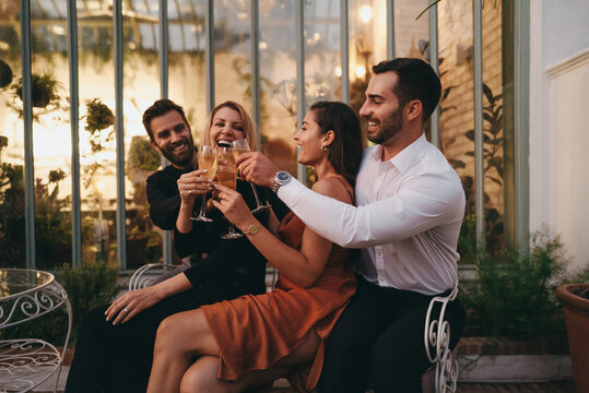 Cheerful couple friends toasting with wineglasses on a double da