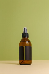 Moisturizing serum for dry skin with pipette on green background