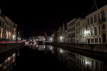Fototapeta na wymiar Artistic long-exposure night photo from the downtown of Bruges, Belgium Car trail lights trails.