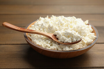Delicious fresh cottage cheese on wooden table, closeup