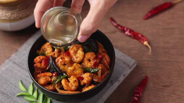 Serving Shrimp masala fish curry Chemmeen curry tiger Prawns balchao Curry 4K video footage. Spicy Kerala fish curry Indian seafood non veg food side dish rice appam Goan Tamil Nadu Bengal Sri Lankan 