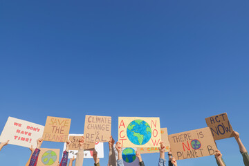 Group of people with posters protesting against climate change outdoors, closeup - obrazy, fototapety, plakaty